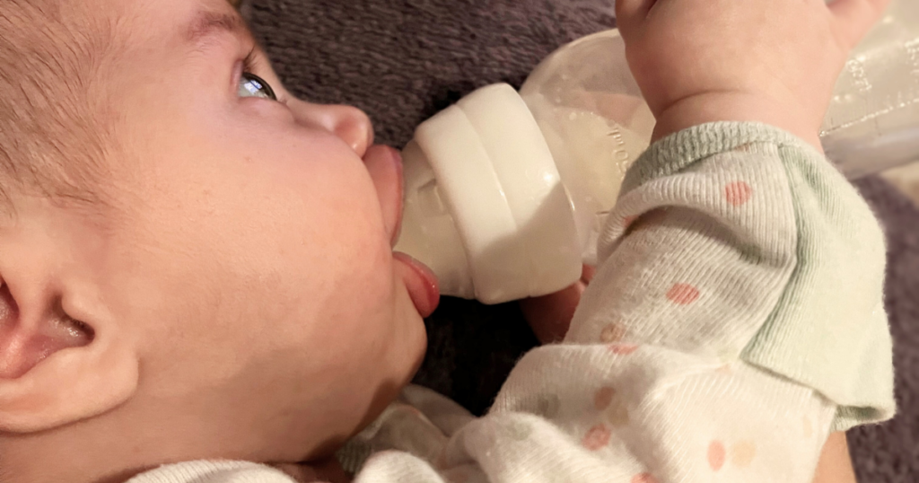 Baby showing good oral function with a strong latch on bottle.